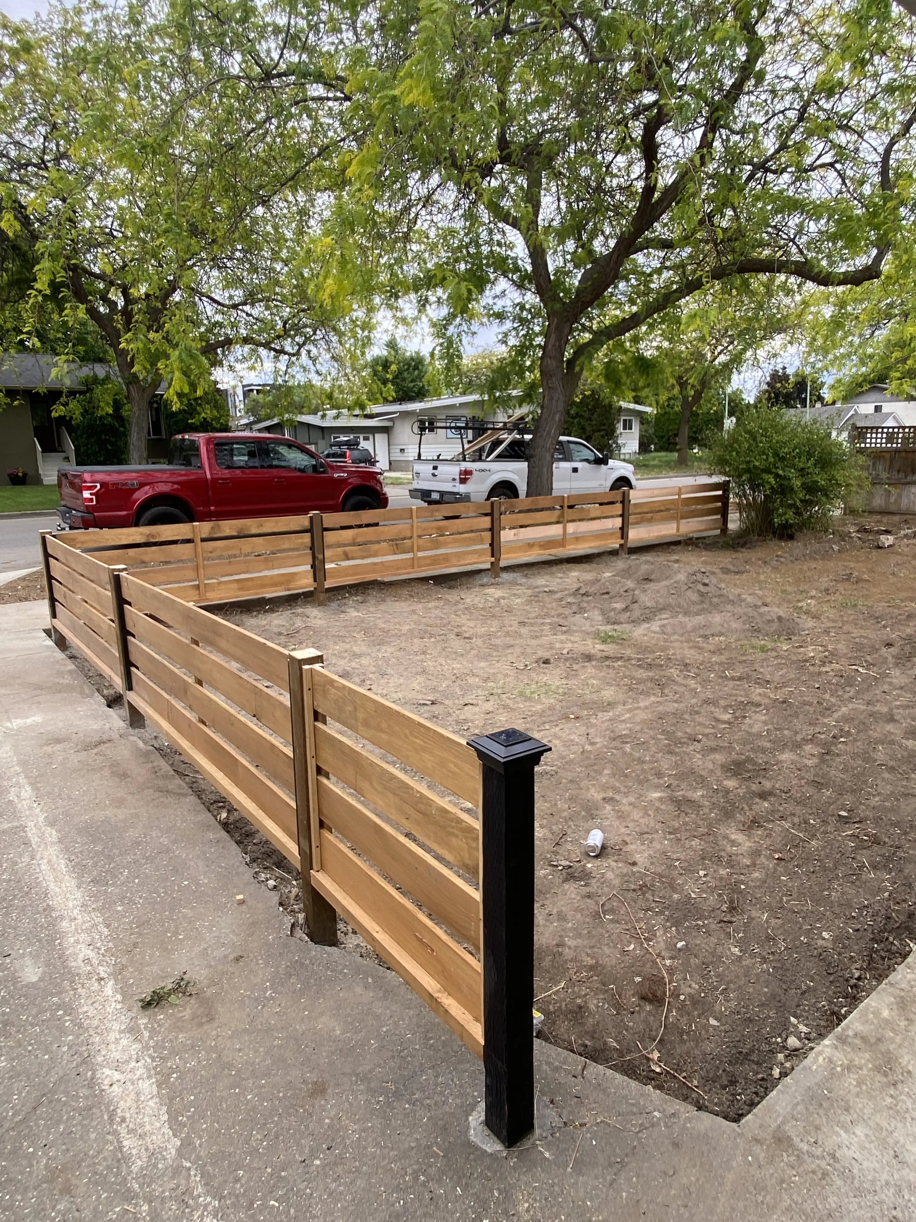 Horizontal cedar fence with black metal posts
